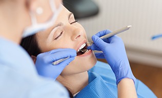 Relaxed woman receiving dental care