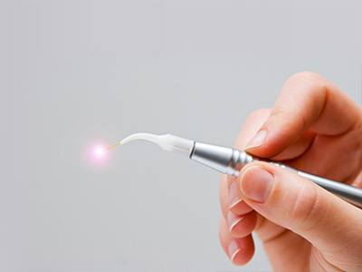 Hand holding soft tissue laser tool