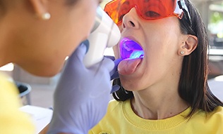 Woman receiving oral cancer screening