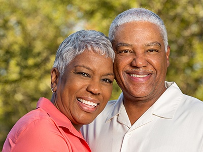 Smiling man and woman outdoors