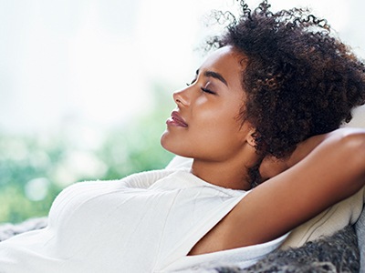 Relaxed woman with heands behind head