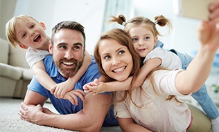 Mother father and two kids laughing together