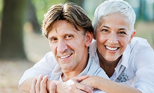 Smiling older man and woman outdoors