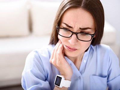 Woman holding jaw in pain